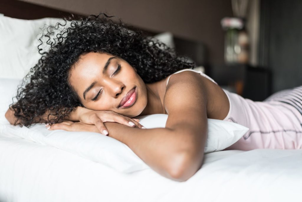 Women & Sleep Young woman resting on bed