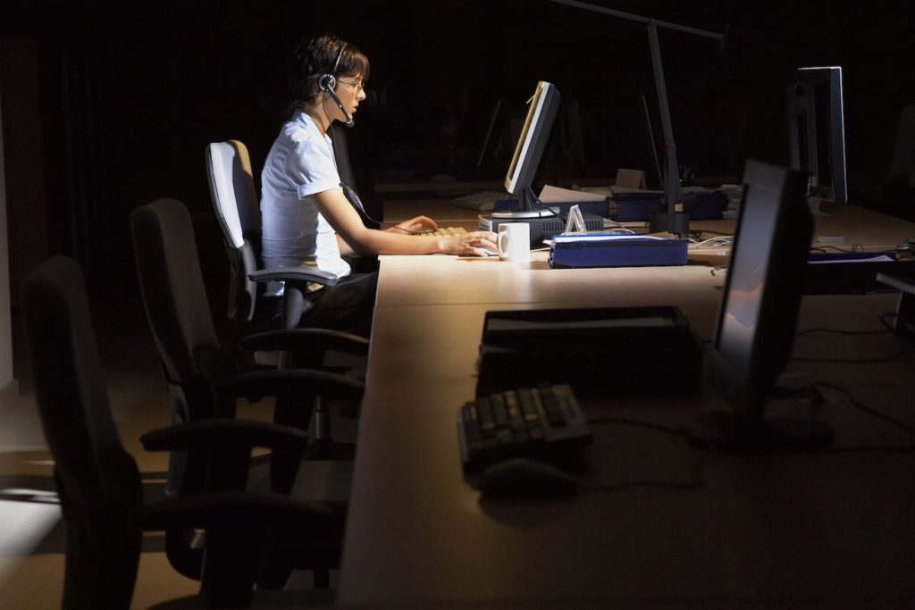 Shift Work Disorder in the Workplace woman working at a desk at night