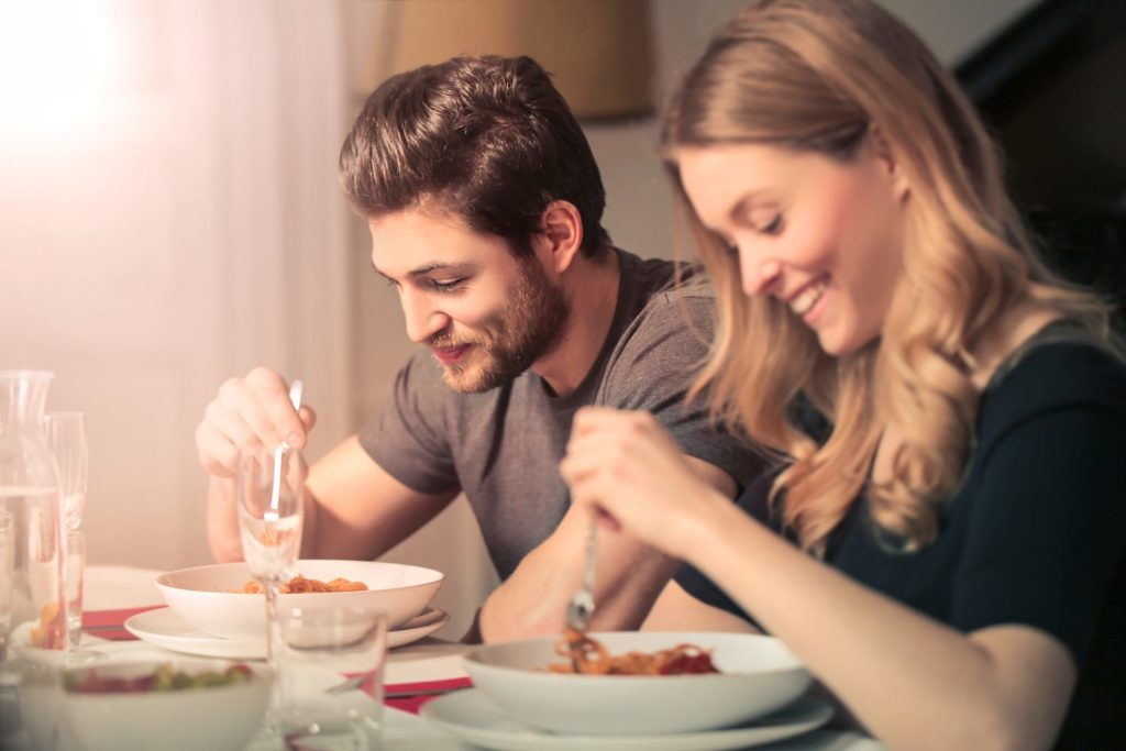 Lack of Sleep May Increase Calorie Consumption couple eating dinner