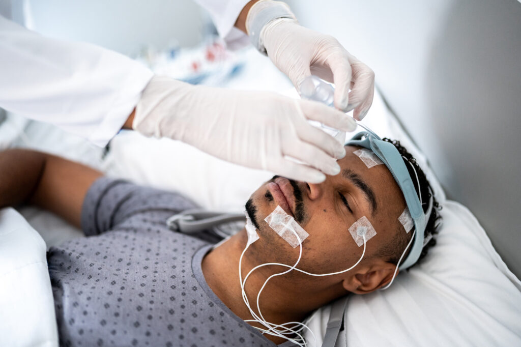 Sleep Clinics and Centers A doctor prepares a patient for a sleep study