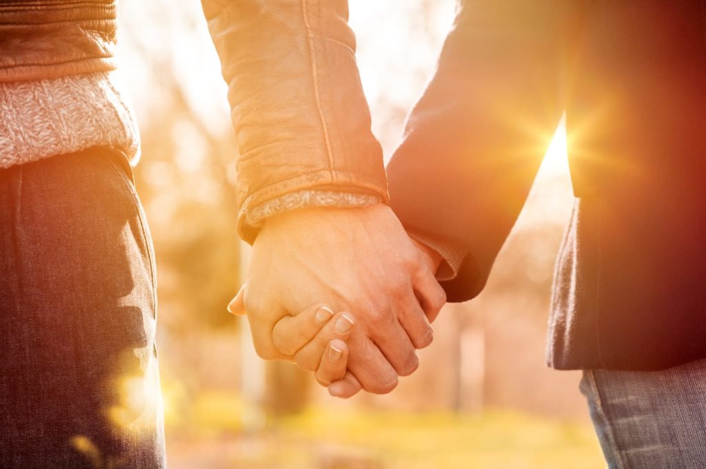 What Does It Mean When You Dream About Your Ex? Couple holding hands