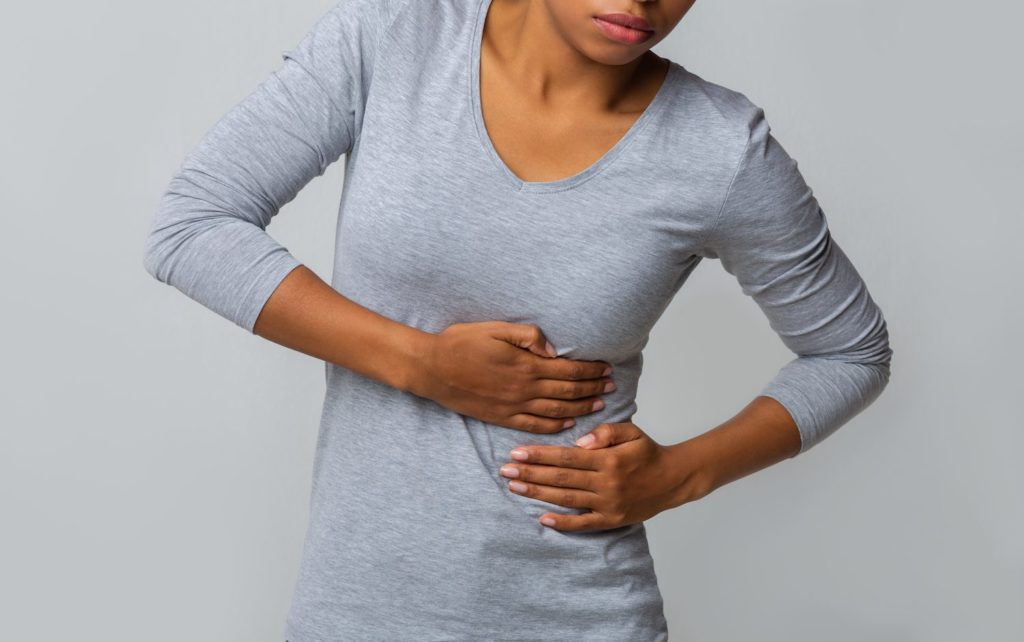 Rest and Recovery: How to Sleep With Intercostal Muscle Strain A woman clasps her side in response to intercostal muscle strain