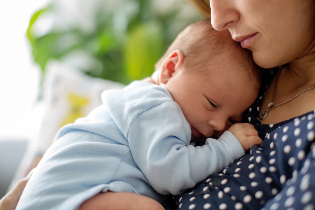 Newborn Snoring A woman holds a newborn
